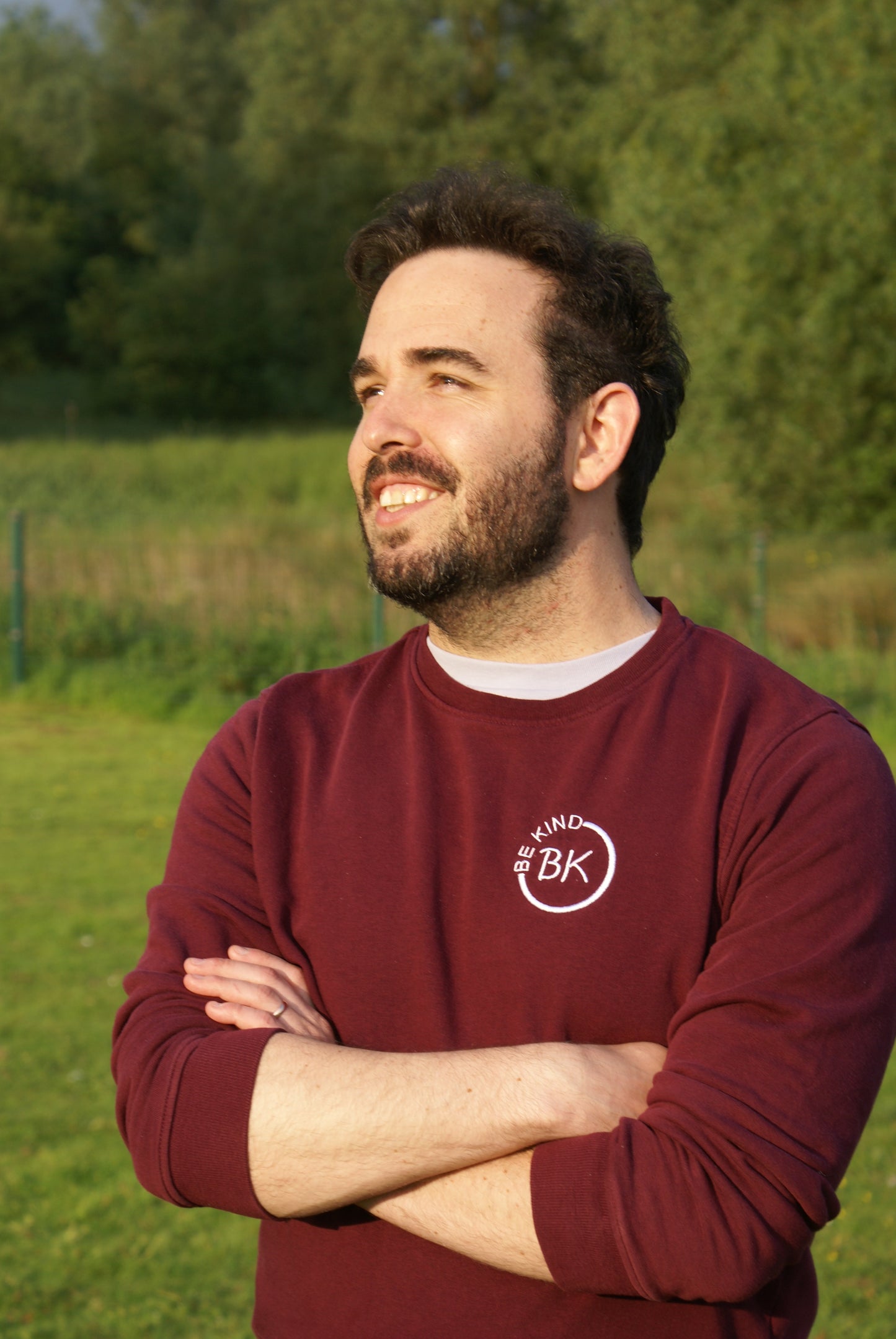 A man looks to the east, he's wearing an Organic Cotton Burgundy sweatshirt from Be Kind Apparel's Freestyle Range